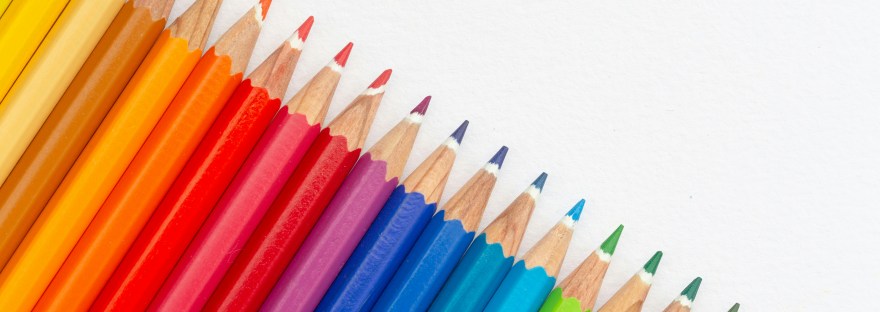 Colored pencils laying in a row.